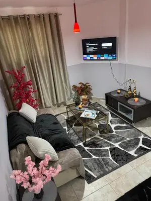 a living room with a couch and a tv at Modernes Komfort mit Smart TV & Power W-LAN, Strandnähe in Hurghada in Hurghada