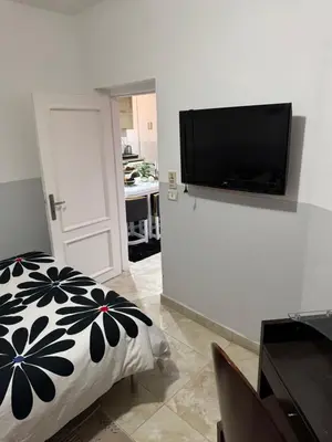 a bedroom with a flat screen tv on a wall at Modernes Komfort mit Smart TV & Power W-LAN, Strandnähe in Hurghada in Hurghada