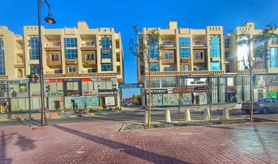 a street with tall buildings in a city at Andalus in in Hurghada