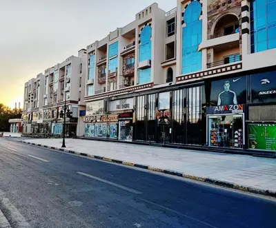 an empty street in front of a building at Andalus in in Hurghada