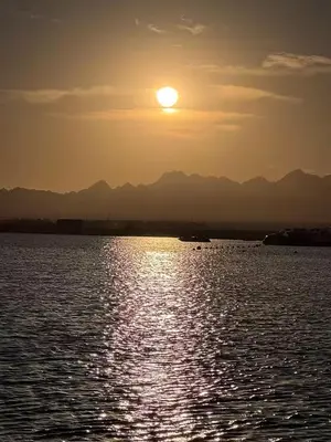 a sun setting over a large body of water at Somabay-Mesca - Relaxing Ground Floor in Hurghada