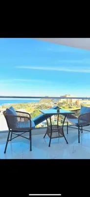three benches and a table with a view of the ocean at Adler-Hurghada Holiday apartment sea view rooftop pool 80m to beach in Hurghada
