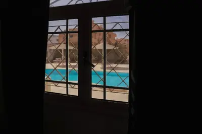 a window with a view of a swimming pool at Elaskary in Hurghada
