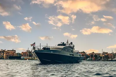 a large boat in the water with a city in the background at Contesa Do in Hurghada