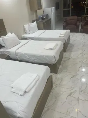 a group of three beds in a room at vision suites Arbia Hurghada in Hurghada