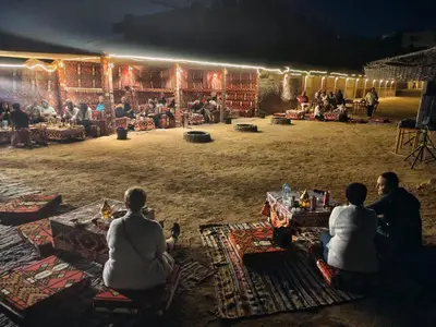 a group of people sitting on the floor of a stage at vision suites Arbia Hurghada in Hurghada