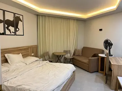 a hotel room with a bed and a couch at Scandic resort private beach in Hurghada