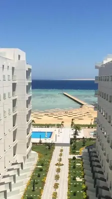 a view of a building and the beach at Scandic resort private beach in Hurghada