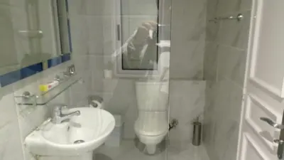 a white bathroom with a sink and a toilet at Jamaica Dream in Luxor