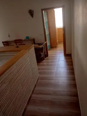 a room with a wooden floor and a hallway at City centre Carrefour in Hurghada