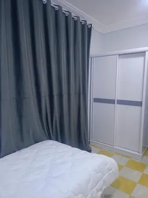 a bedroom with a bed and a window at Larose Apartment in Hurghada