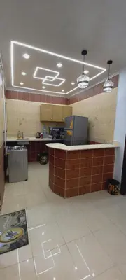 a large kitchen with a counter in a building at Larose Apartment in Hurghada