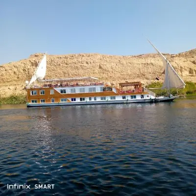 a boat on the water with a building on it at Lucky in Luxor