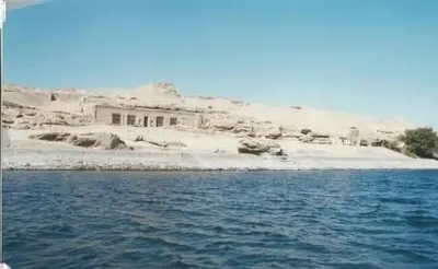 a house sitting on top of a beach next to the water at Lucky Nile Tours in Luxor