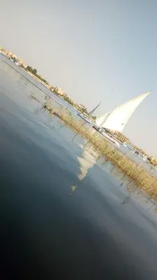 a view of the wing of an airplane flying over water at Lucky Nile Tours in Luxor