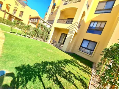 an apartment building with a lawn in front of it at Gouna -tawila in Hurghada