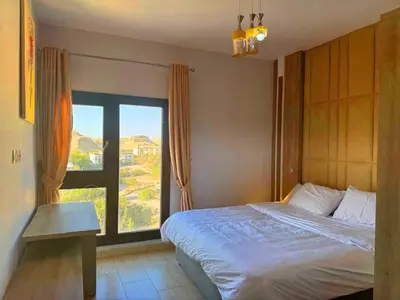 a bedroom with a bed and a large window at ALDAU LaLa in Hurghada