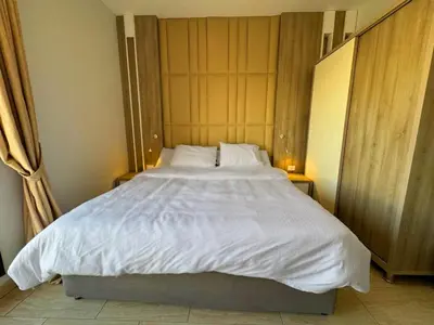 a bedroom with a large bed with white sheets and pillows at ALDAU LaLa in Hurghada
