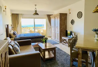 a living room with a couch and a table at vintage sea view apartment in Hurghada