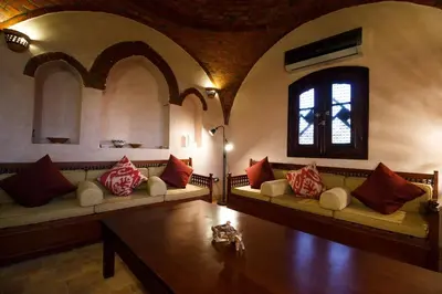 a living room with couches and a table and a window at Riverbank House in Luxor