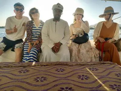 a group of people sitting on a boat at فلوكة نيلية in Luxor