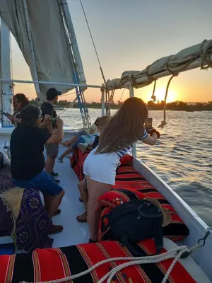 a group of people on a sail boat in the water at فلوكة نيلية in Luxor
