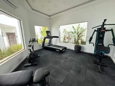 a gym with two exercise bikes and two windows at Arаbian Suites by Imperial in Hurghada
