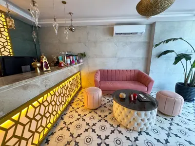 a living room with a pink couch and a table at Arаbian Suites by Imperial in Hurghada