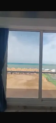 a window with a view of a beach and the ocean at Sea view chalet hurghada in Hurghada