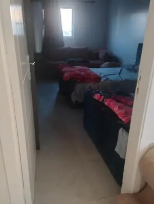 a living room with two beds and a couch at Studio in Villa in Hurghada