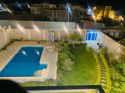 an overhead view of a swimming pool in a yard at night at Studio in Villa in Hurghada