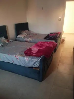 two twin beds in a room with at Studio in Villa in Hurghada