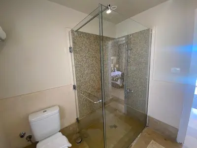 a bathroom with a glass shower and a toilet at Cozy Suite in Azzurra Resort Sahl Hasheesh 95 SqM in Hurghada