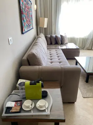 a living room with a couch and a table at Cozy Suite in Azzurra Resort Sahl Hasheesh 95 SqM in Hurghada