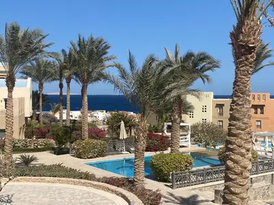 a view of a resort with palm trees and the ocean at Cozy studio in Azzurra Resort Sahl Hasheesh 65 Sq M in Hurghada