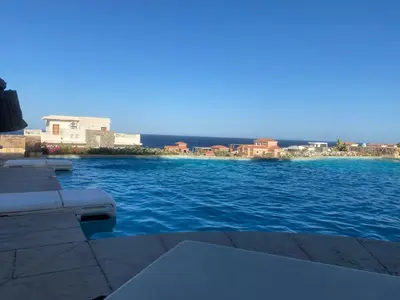 a view of a body of water with buildings in the background at Cozy studio in Azzurra Resort Sahl Hasheesh 65 Sq M in Hurghada
