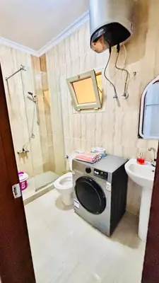 a bathroom with a washing machine and a toilet at Boho Oasis - Studio Hurghada Red Sea in Hurghada