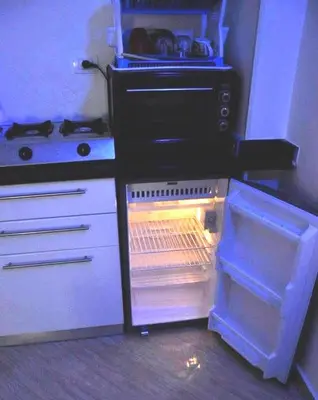 an empty refrigerator with its door open in a kitchen at Boho Oasis - Studio Hurghada Red Sea in Hurghada