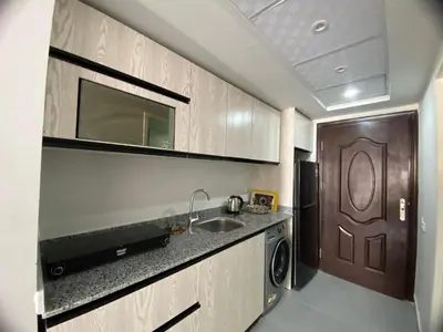 a kitchen with a sink and a brown door at Scandic Resort Hurghada in Hurghada
