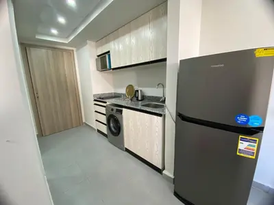 a kitchen with a stainless steel refrigerator and a dishwasher at Scandic Resort Hurghada in Hurghada