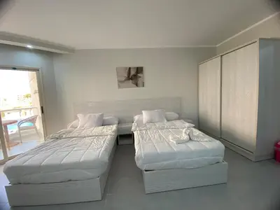 two beds in a small room with at Scandic Resort Hurghada in Hurghada