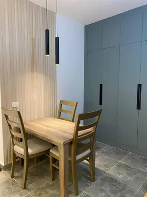 a wooden table and chairs in a room at Aqva infinity resort c102 in Hurghada
