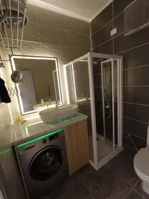 a bathroom with a washing machine and a sink at Aqva infinity resort c102 in Hurghada