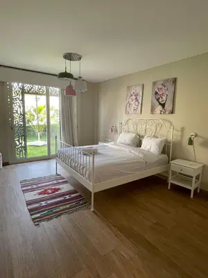 a bedroom with a white bed and a large window at El gouna mangroovy M3-3D-01 ground floor in Hurghada