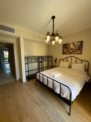 a bedroom with a large bed with a chandelier at El gouna mangroovy M3-3D-01 ground floor in Hurghada