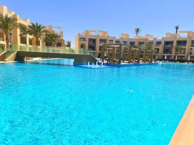 a large pool of blue water in front of buildings at El gouna mangroovy M3-3D-01 ground floor in Hurghada