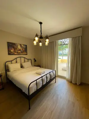 a bedroom with a bed and a large window at El gouna mangroovy M3-3D-01 ground floor in Hurghada