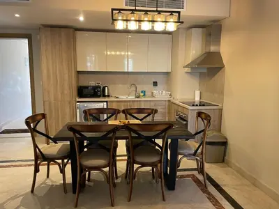 a kitchen with a dining room table and chairs at El gouna mangroovy M3-3D-01 ground floor in Hurghada