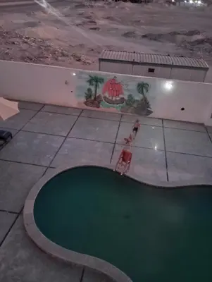 a woman standing in front of a swimming pool at tiba A F B view in Hurghada