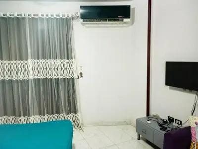 a living room with a couch and a tv at Taiba View Studio in Hurghada